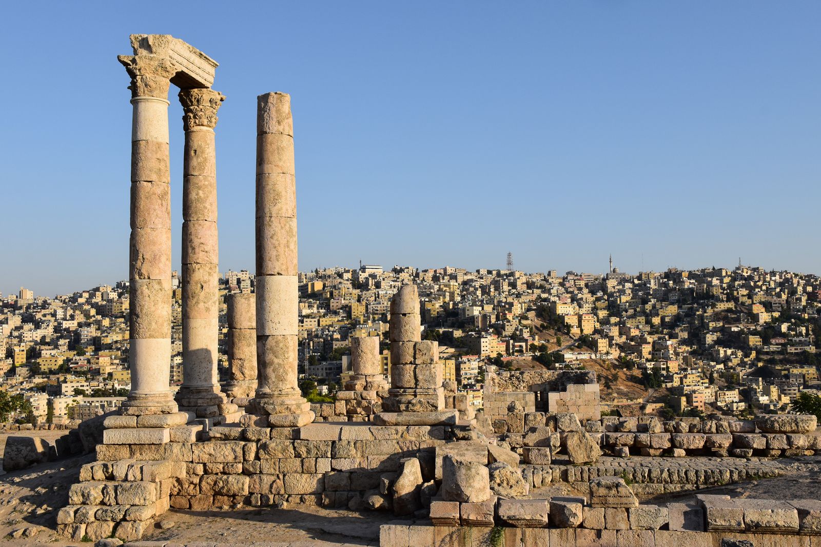 Majestic view of the Temple of Hercules ruins against Amman's sprawling cityscape.